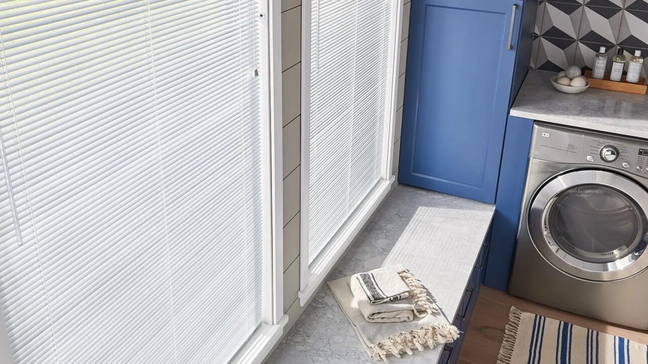White aluminum blinds shown in a laundry room
