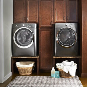 Laundry room with laundry machines hidden in cabinetry