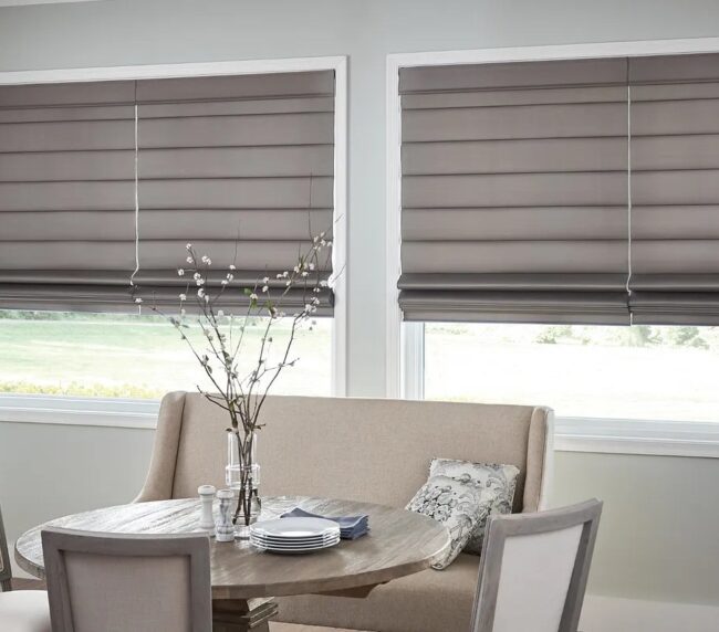Picture of taupe colored roman shades on dining room windows