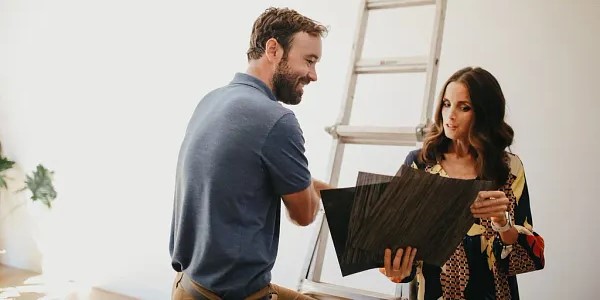window treatments installer and woman discussing a window treatments installation